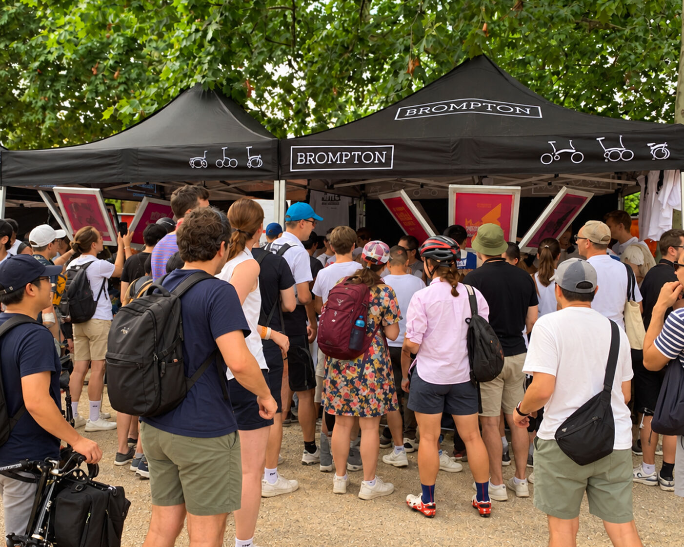 Crowds of cyclists gathered around Brompton's live screen printing gazebos on The Mall in London